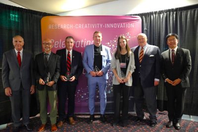 winners posing with university leaders