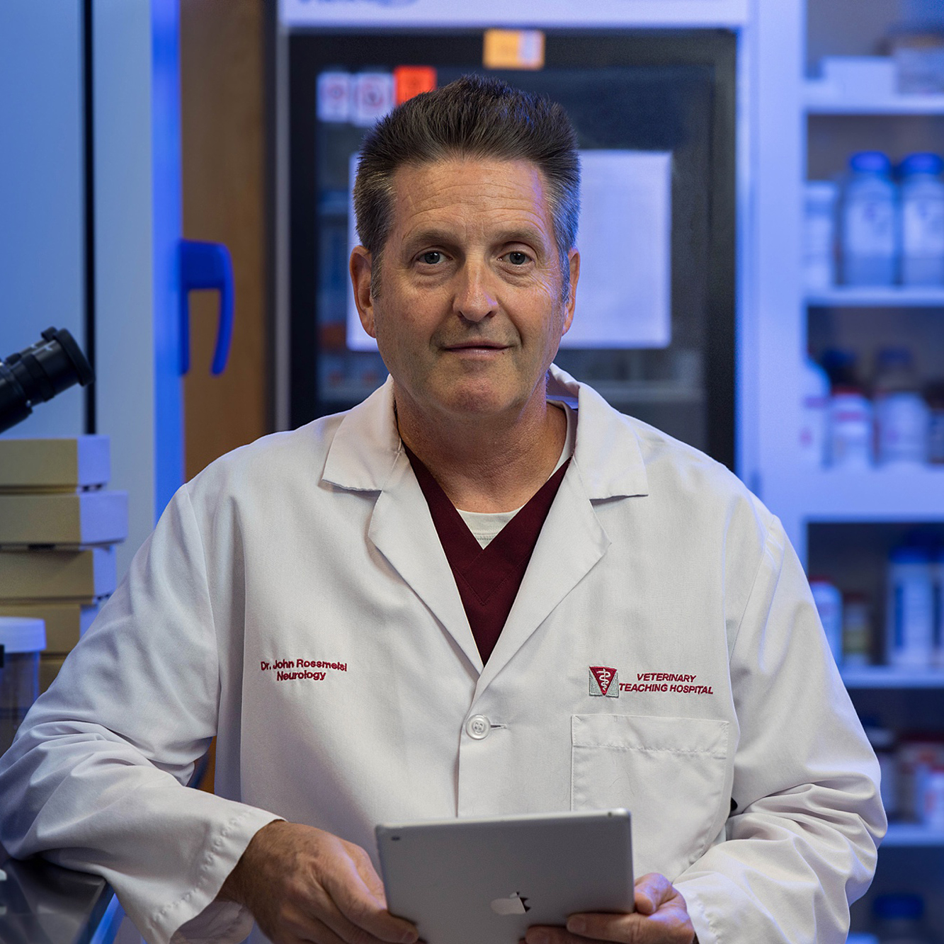 John Rossmeisl in a white lab coat in his lab.