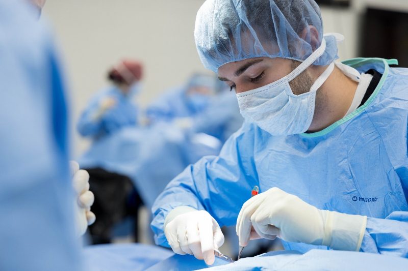 Veterinary student in a gown during a mock surgery.