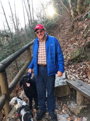 Dr. Kevin Pelzer on a hike with his two dogs.