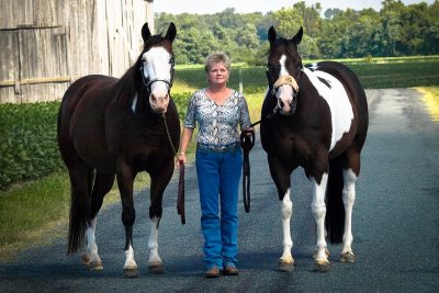 Gena Clifton with her two american paint horses. 