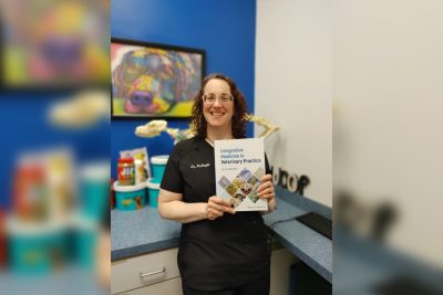 Lisa McFaddin (at center) holding the textbook she has written