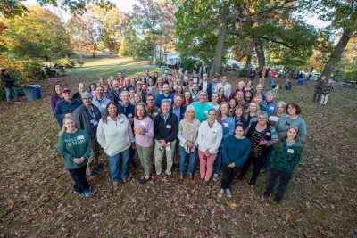 Alumni gather for a group photo at the College Celebration in the Grove during Connect 2022 at the Virginia-Maryland College of Veterinary Medicine.