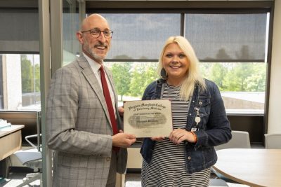 Dean Dan Givens presents the June 2024 Staff Member of the Month award to Liz Bowman.