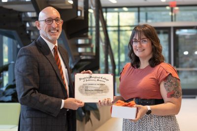 Dean M. Dan Givens presenting the Staff Member of the Month award for October 2024 to Katherine Harshman, Development Associate in the Advancement Office at the Virginia-Maryland College of Veterinary Medicine 