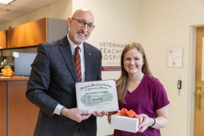 M. Dan Givens (at left) presenting the Staff Member of the Month award to Carrie Orey (at right) in the Small Animal Teaching Hospital lobby at the Veterinary Teaching Hospital