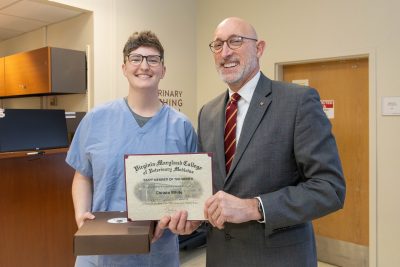 Dean M. Dan Givens (at right) and Christa White (at left), Ophthalmology Technician in the Small Animal Clinic at the Veterinary Teaching Hospital receiving the Staff Member of the Month award for January 2025.