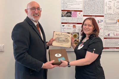 Dean Dan M. Givens (at left) presenting the Staff Member of the Month award to Kelsay Bratton, Oncology Technician at the Animal Cancer Care and Research Center for February of 2025. 