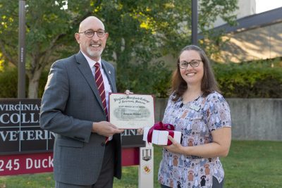 (From left) Dean M. Dan Givens presenting Amanda Havens, Theriogenology LVT, with the September Staff Member of the Month award.