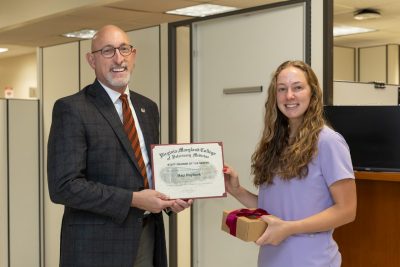 Dean Dan M. Givens (at left) presenting the Staff Member of the Month award to Maci Raybuck, Ophthalmology Technician at the Veterinary Teaching Hospital for October of 2025. 