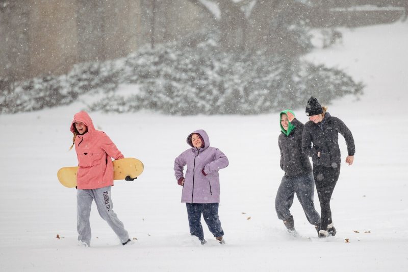 Students play in the snow