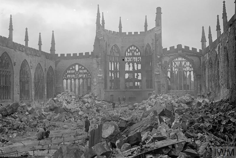 A black and white photograph of the  destroyed Coventry Cathedral after an air raid.