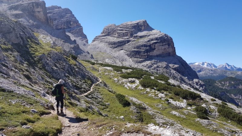 Photo of a hiker on a trail in the Dolomites of Italy