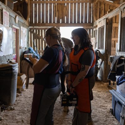 People standing in a barn.