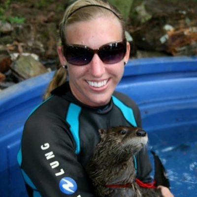 Woman holding an otter.