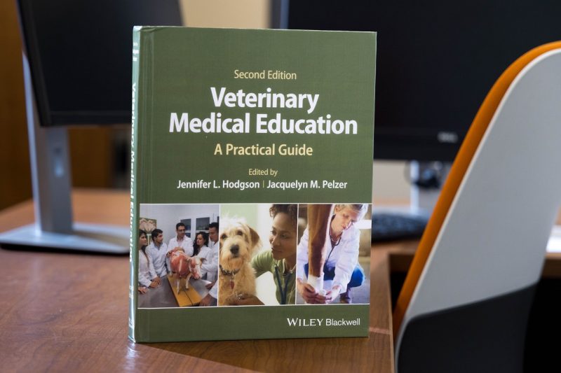 Veterinary Medical Education textbook on a desk.