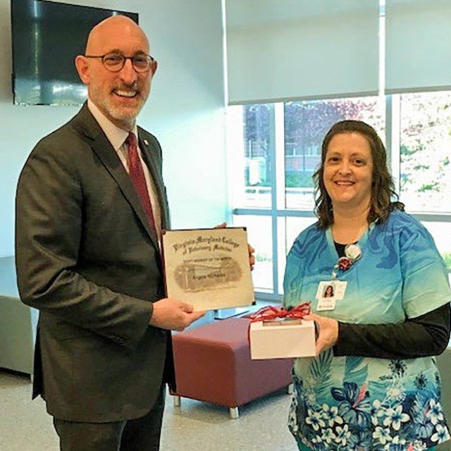Dean Dan Givens presents the May 2023 Staff Member of the Month award to Angela Richards.